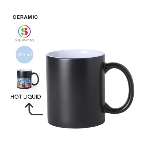 Taza de cerámica de 350ml de capacidad con exterior en color negro e interior en blanco. Especialmente diseñada para marcaje en sublimación. Presentada en caja 