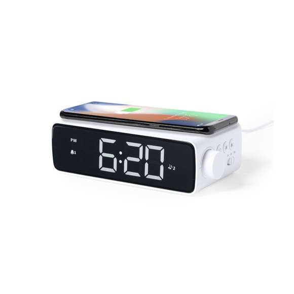 Reloj multifunción de elegante diseño en color blanco con cargador inalámbrico de 10W integrado y lámpara led integrada. Con función fecha/hora, alarma y lámpara de 36 ledes con intensidad de luz regulable. Conexión USB, con cable Tipo C incluido de 100 cm y alimentación auxiliar a pilas de botón (incluida). Compatible con dispositivos equipados con tecnología de carga inalámbrica. Presentado en atractiva caja de diseño.En cumplimiento con los requisitos de seguridad: Sistema de protección contra sobrecalentamiento. Sistema de protección contra sobrecarga.