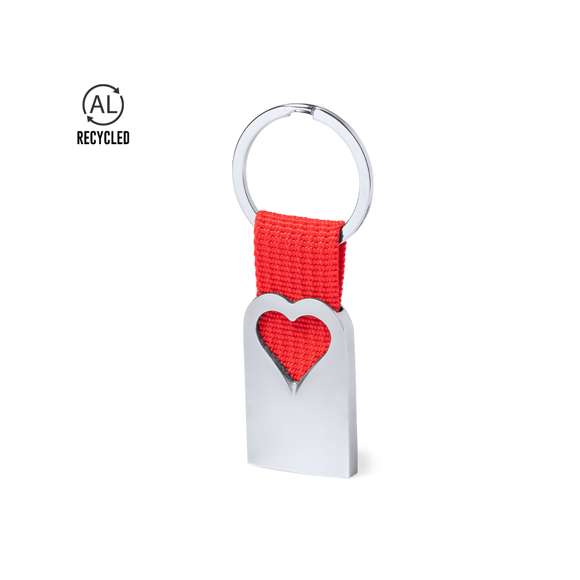 Original llavero corazón con cuerpo en aluminio reciclado de acabado plateado. Cuerpo con corazón troquelado y cinta en color. Amplia superficie de marcaje y distintivo aluminio reciclado. Con anilla llavero metálica a juego y presentado en bolsa individual con cartón kraft.El aluminio reciclado es un material con posibilidades de reciclaje casi infinitas, sin perder sus propiedades originales y consumiendo menos energía en este proceso.