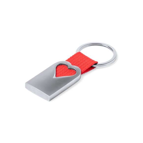 Original llavero corazón con cuerpo en aluminio reciclado de acabado plateado. Cuerpo con corazón troquelado y cinta en color. Amplia superficie de marcaje y distintivo aluminio reciclado. Con anilla llavero metálica a juego y presentado en bolsa individual con cartón kraft.El aluminio reciclado es un material con posibilidades de reciclaje casi infinitas, sin perder sus propiedades originales y consumiendo menos energía en este proceso.