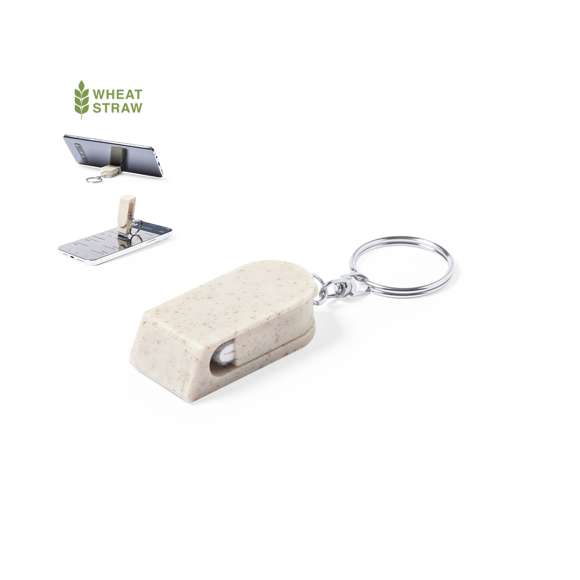 Llavero soporte para smartphone de línea nature, fabricado en caña de trigo. Con mecanismo giratorio y accesorio limpiapantallas incluido. Anilla metálica cromada.La caña de trigo fomenta la utilización de materias primas naturales, reduciendo así las emisiones contaminantes.