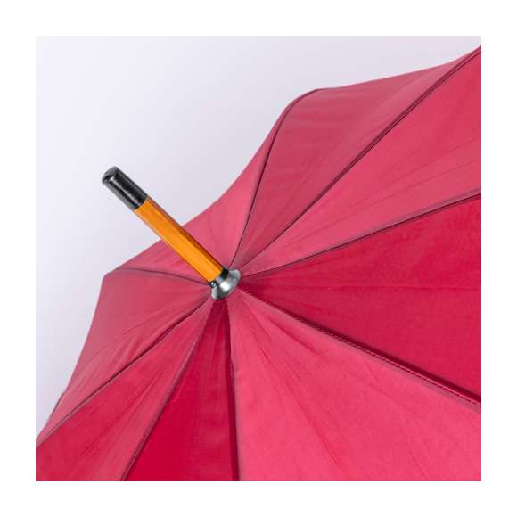 Paraguas de 8 paneles y 105 cm de diámetro, en resistente material poliéster 190T. De apertura automática, con mango curvado y caña, ambos en madera. Varillas metálicas en color negro, tira con cierre de velcro y disponible en variada gama de colores.