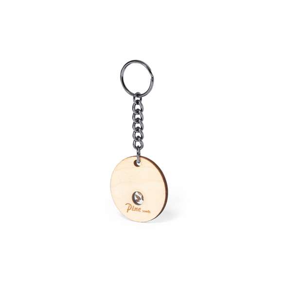 Llavero en suave y elegante madera de haya. Incluye cápsula con semillas de pino. Un respetuoso y sostenible regalo con el que fomentar y promover el cuidado del medio ambiente. Presentado en caja individual de diseño kraft.