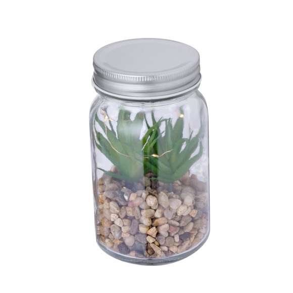 Planta decorativa sobre una base de piedras, en tarro de cristal de borosilicato. Iluminada por 5 LEDs que funcionan con 3 pilas AAA (no incluidas). Presentado en caja de diseño kraft.Fabricado en cristal de borosilicato, que ofrece una resistencia y durabilidad excepcionales, alargando su vida útil y pudiendo ser reutilizado infinidad de veces.