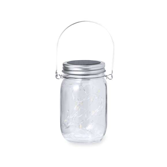 Original lámpara tarro solar, fabricada en resistente material cristal y con una tira interior decorativa de 20 LEDs. Incluye tapadera a rosca metálica con minipanel solar de recarga integrado y una batería recargable de 300 mAh. Con práctica asa para transportar o colgar, y presentada en caja individual de diseño kraft.