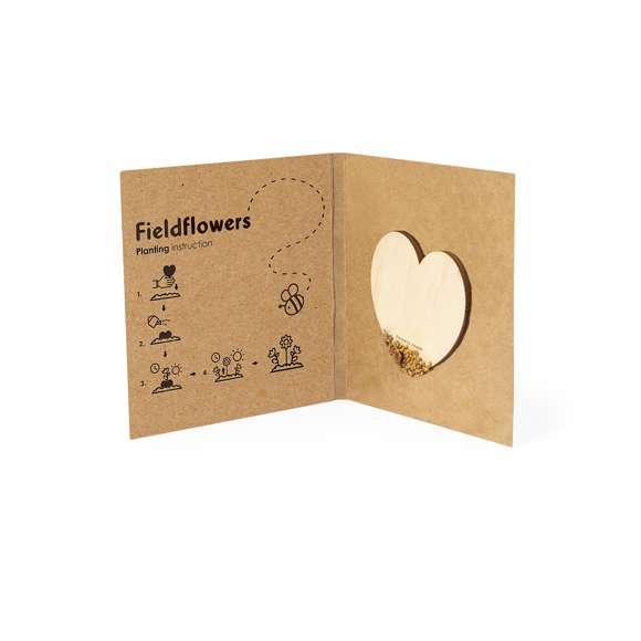 Corazón de semillas fabricado en madera natural, con semillas de flores silvestres listas para plantar. Presentado en una elegante tarjeta de cartón reciclado, con instrucciones de plantado y amplia superficie de marcaje.