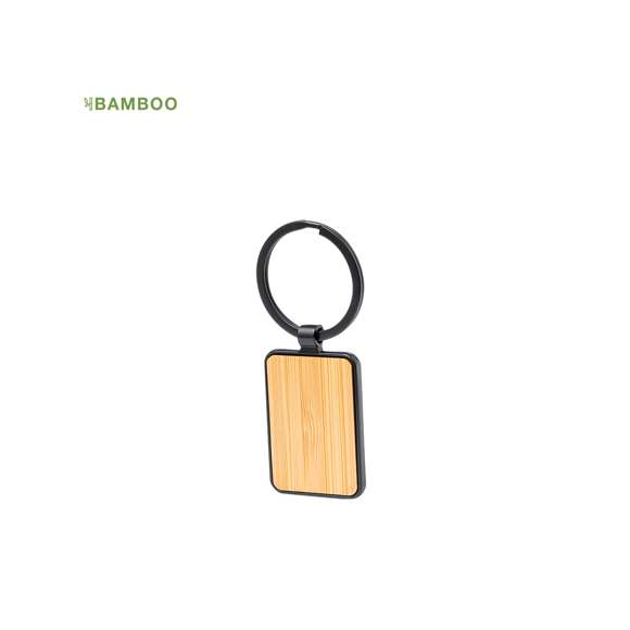 Llavero de elegante diseño, fabricado en metal pulido de color negro, con una cara en suave bambú. Especialmente diseñado par marcaje en láser y disponible en diseño rectangular y circular. Presentado individualmente bolsa de papel reciclado.