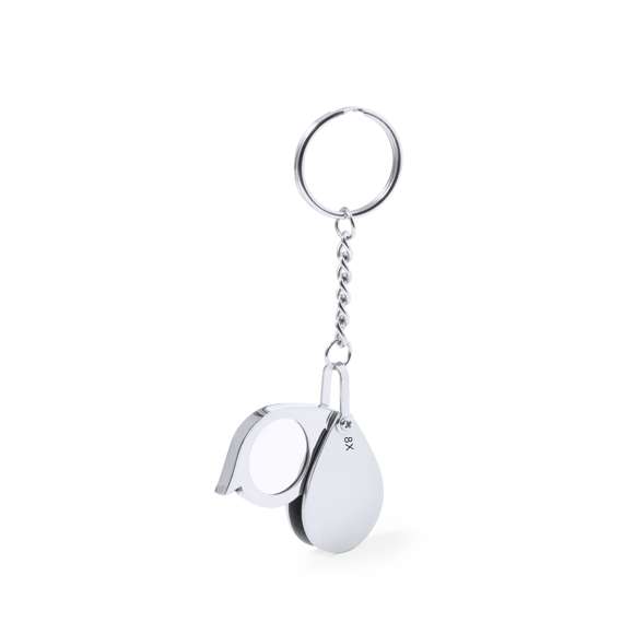 Práctico llavero lupa plegable, con aumento de 8x y fabricado en resistente metal. Fácil de transportar por su reducido tamaño y presentado en caja de cartón negra.
