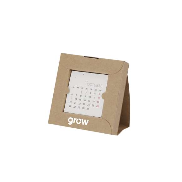 Calendario plantable fabricado en papel de semilla. Incluye 13 hojas con semillas de petunia de colores surtidos, convirtiéndolo en papel plantable después de su vida útil. Diseño de mes en curso, con festividades nacionales marcadas en rojo y autonómicas en verde. Presentado en caja soporte de cartón.