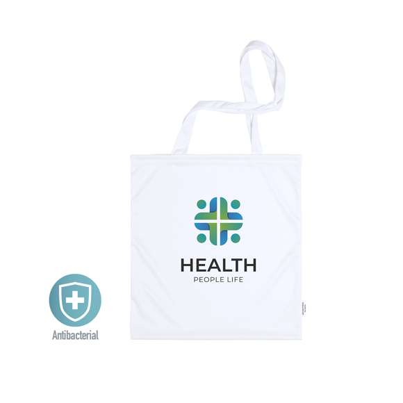Bolsa antibacteriana de alta calidad en suave poliéster elástico con propiedades hidrófugas, fácil de imprimir. Con etiqueta distintiva antibacteriana. Tamaño 37x41 cm, de acabado cosido y con asas largas. Resistencia de hasta 7kg de peso.Los productos con tratamientos antibacterianos son capaces de reducir drásticamente las cargas bacterianas presentes en las superficies de los materiales, gracias a la incorporación de agentes microbianos permanentes estáticos, con alta efectividad para inhibir y prevenir la contaminación bacteriana.Artículo de acuerdo al estándar ISO 20743, que determina la actividad antibacteriana en productos textiles, lo que permite conocer la efectividad de inhibición microbiana que tienen los aditivos sobre los objetos tratados mediante una evaluación cuantitativa.