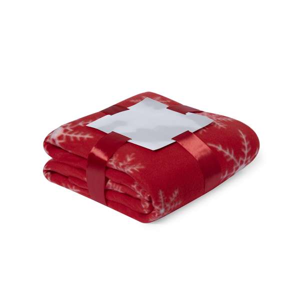 Manta de 130x160cm en original diseño de navidad de color rojo con motivos navideños en blanco. En suave y cálido material polar fleece de 200g/m2 con tratamiento antipilling. Presentada con cartón de color plateado y cinta lazo a juego en suave poliéster.