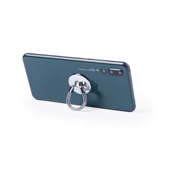 Soporte selfie en metal cromado para smartphone. De elegante diseño y con adhesivo 3M, de fijación extra fuerte y libre de residuos al despegarlo del dispositivo. Con doble anilla soporte posterior, para dedo y rejilla del salpicadero del vehículo. Presentado bolsita de diseño individual.