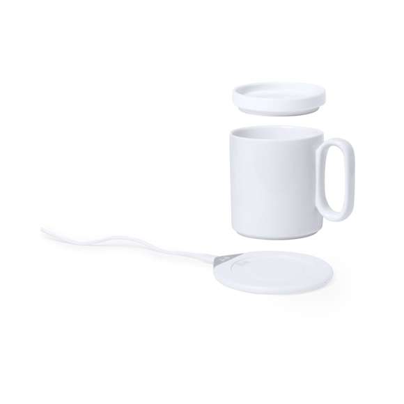 Calentador de tazas con cargador inalámbrico integrado de carga rápida -10W-. Con taza de cerámica de 350 ml, especialmente diseñada para calentar y mantener la temperatura de la bebida, con tapa a juego. Incluye cargador de pared y cable de carga Tipo C. Set presentado en atractiva caja de diseño.