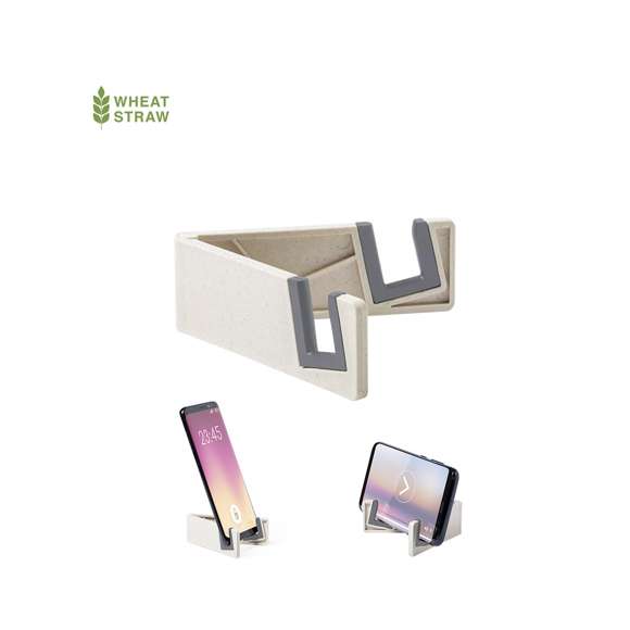 Soporte para dispositivo móvil de línea nature. Fabricado en caña de trigo/PP, para así fomentar la utilización de materias primas naturales y reducir las emisiones contaminantes.Patas plegables con topes antideslizantes en PVC, especialmente diseñado para marcaje en tampografía.