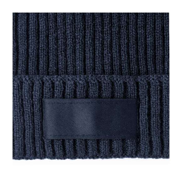 Suave y cálido gorro de punto de canalé, fabricado en material acrílico elástico. Incluye etiqueta frontal a juego para marcaje, disponible en variada gama de colores.