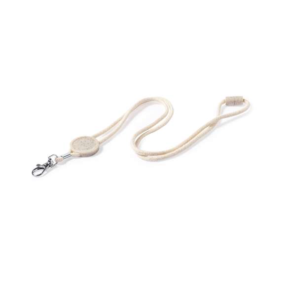 Lanyard de línea nature fabricado en resistente algodón 100%. Accesorio circular para personalización y cierre de seguridad en cuello fabricados en caña de trigo, con mosquetón metálico giratorio.La caña de trigo fomenta la utilización de materias primas naturales, reduciendo así las emisiones contaminantes.