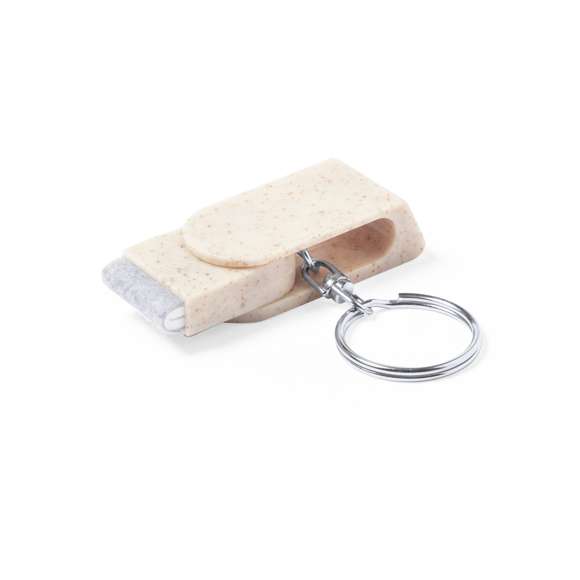Llavero soporte para smartphone de línea nature, fabricado en caña de trigo. Con mecanismo giratorio y accesorio limpiapantallas incluido. Anilla metálica cromada.La caña de trigo fomenta la utilización de materias primas naturales, reduciendo así las emisiones contaminantes.