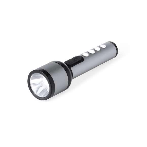 Linterna potente fabricada en aluminio con un diseño elegante en acabado gris metalizado con detalles en negro. Cuenta con 1 LED frontal para una iluminación focalizada y 4 luces COB en el mango para una dispersión más amplia de la luz. Ofrece 3 modos de iluminación: fija, intermitente lenta y rápida, adaptándose a diversas necesidades. Esta linterna es recargable mediante su batería de 1200 mAh, con el cable de carga incluido. Presentada individualmente en caja de diseño kraft.