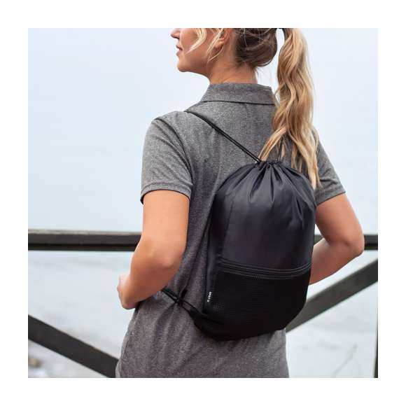 Mochila de cuerdas fabricada en suave poliéster RPET 210D. Cuenta con cuerdas de autocierre negras en argollas de tela. Incluye un bolsillo frontal de rejilla con cierre de cremallera a juego. Logotipo RPET en etiqueta lateral y está disponible en una variada gama de colores (color blanco especialmente fabricado para marcaje en sublimación).El material RPET se elabora a partir de plástico reciclado, para así fomentar la reutilización de residuos plásticos y ayudar a la sostenibilidad del planeta.