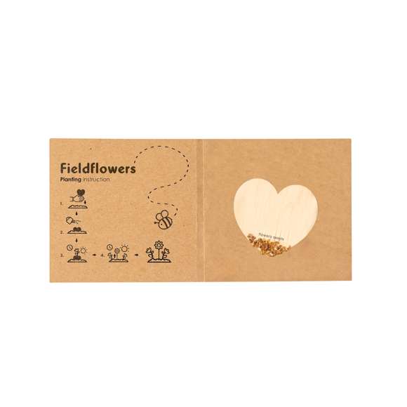 Corazón de semillas fabricado en madera natural, con semillas de flores silvestres listas para plantar. Presentado en una elegante tarjeta de cartón reciclado, con instrucciones de plantado y amplia superficie de marcaje.
