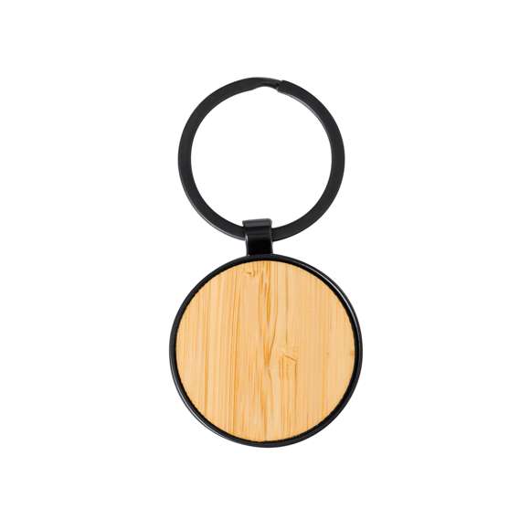 Llavero de elegante diseño, fabricado en metal pulido de color negro, con una cara en suave bambú. Especialmente diseñado par marcaje en láser y disponible en diseño rectangular y circular. Presentado individualmente bolsa de papel reciclado.
