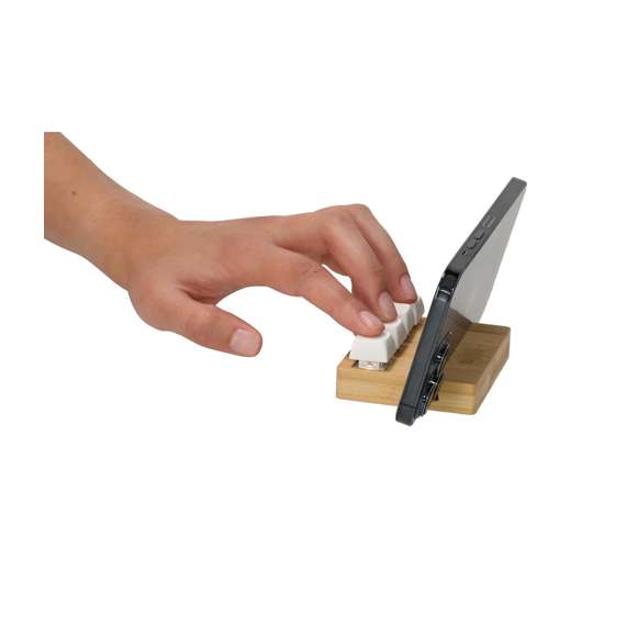 Original soporte antiestrés fabricado en bambú. Cuenta con cuatro teclas que imitan a un teclado mecánico, permitiendo pulsarlas de forma independiente tantas veces como sea necesario. Incluye un práctico soporte para dispositivos móviles, combinando funcionalidad y alivio del estrés en un elegante diseño.Materiales como el Bambú fomentan la utilización de materias primas naturales, reduciendo las emisiones contaminantes. Proviene de una planta de gran resistencia y versatilidad, con crecimiento y regeneración rápidos, siendo una excelente alternativa al uso de madera tradicional.