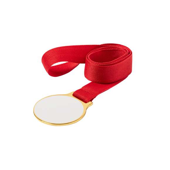 Medalla metálica con acabado dorado liso, especialmente diseñada para marcaje en sublimación (no integrada en el producto, ideal para imprimir y pegar posteriormente). Cinta de poliéster en color rojo incluida.