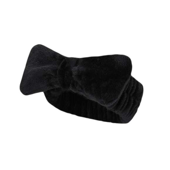Diadema en forma de cinta para el cabello, adornada con un elegante lazo. Confeccionada en suave y elástico poliéster, ideal para facilitar la rutina de lavado facial.