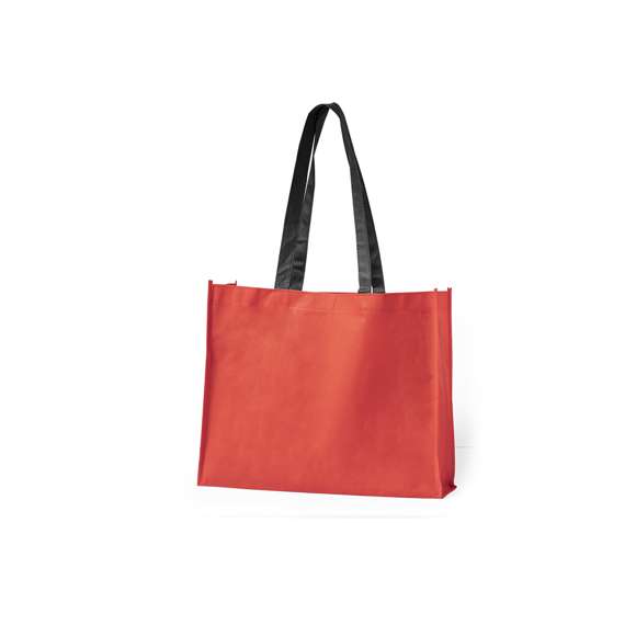 Bolsa en non-woven de 100g/m2, en variada gama de vivos colores. Con asas largas de 70cm en color negro, fuelle reforzado con ribete a juego y acabado cosido.