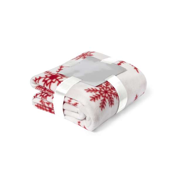 Manta de 130x160cm en original diseño de navidad de color rojo con motivos navideños en blanco. En suave y cálido material polar fleece de 200g/m2 con tratamiento antipilling. Presentada con cartón de color plateado y cinta lazo a juego en suave poliéster.