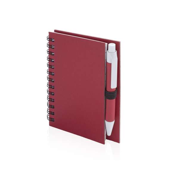 Libreta de anillas con tapas de suave tacto acabadas en resistente cartón reciclado y bolígrafo en cartón reciclado a juego. De atrevidos colores, 50 hojas con distribución a una raya y con soporte para bolígrafo en contraportada.