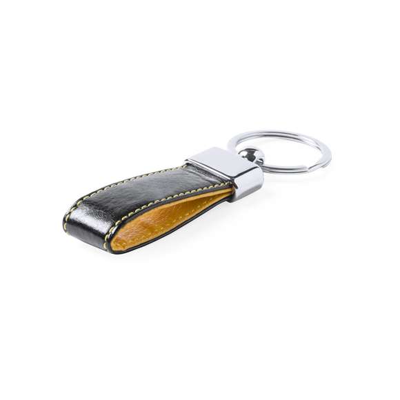Llavero de elegante acabado en polipiel bicolor con accesorio metálico. Presentado en estuche individual troquelado.