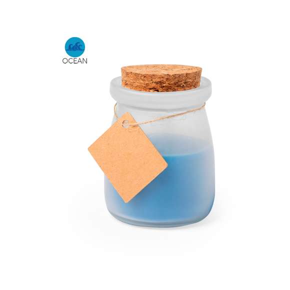  	Original vela tarrito de cristal. Con tapón de corcho y etiqueta de cartón reciclado con hilo para mensajitos. Disponible en varios colores y presentada en caja blanca individual.