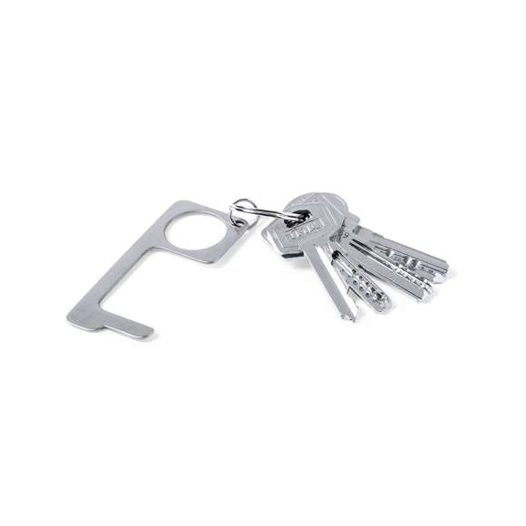 Llavero higiénico anti-contacto, fabricado en resistente acero inox. Especialmente diseñado para evitar tocar con las manos superficies de uso común (picaportes de puertas, interruptores, grifos de uso público, cajeros automáticos...). Con cómodo troquel para el dedo y presentado en bolsita individual. Recomendado para marcaje en láser.