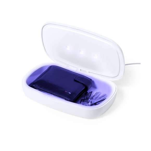 Caja esterilizadora de luz ultravioleta tipo C, con cargador inalámbrico para smartphone integrado en tapa. Especialmente diseñada para la eliminación de microorganismos y bacterias en objetos de uso cotidiano como el smartphone, llaves, gafas, mascarilla, auriculares, smartwatch... Fabricada en resistente material ABS de acabado mate y presentada en atractiva caja individual de diseño.  Fácil de usar, basta con introducir el objeto dentro de la caja. Potencia de bombilla 1W longitud de onda de 270-280 nm, con alimentación mediante cable USB Tipo C de 1m de largo con color a juego. Tiempo de esterilización de 5 y 10 minutos con función auto-apagado.  Disponible manual de usuario en español e inglés. Disponible certificación CE, RoHS y de efectividad germicida. Para un uso adecuado del producto, evitar el contacto con la piel y los ojos.