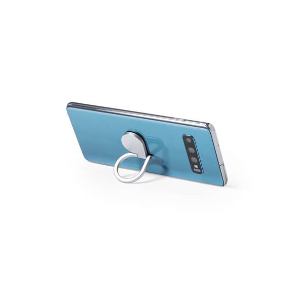 Soporte metálico para smartphone en acabado mate. De elegante diseño y con adhesivo 3M, de fijación extra fuerte y libre de residuos al despegarlo del dispositivo. Con anilla soporte posterior para dedo y presentado en bolsita individual de diseño.