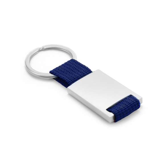Llavero de divertido diseño con cinta de poliéster de variados y vivos colores. Con cuerpo metálico especialmente diseñado para marcaje en láser.