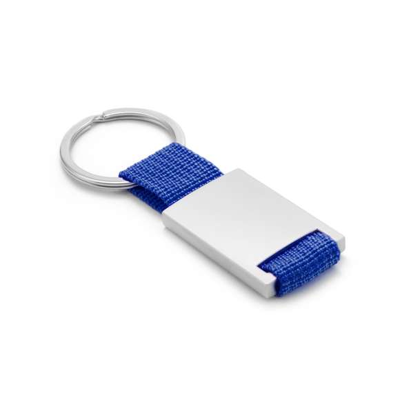 Llavero de divertido diseño con cinta de poliéster de variados y vivos colores. Con cuerpo metálico especialmente diseñado para marcaje en láser.