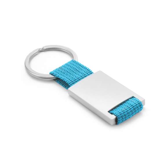 Llavero de divertido diseño con cinta de poliéster de variados y vivos colores. Con cuerpo metálico especialmente diseñado para marcaje en láser.